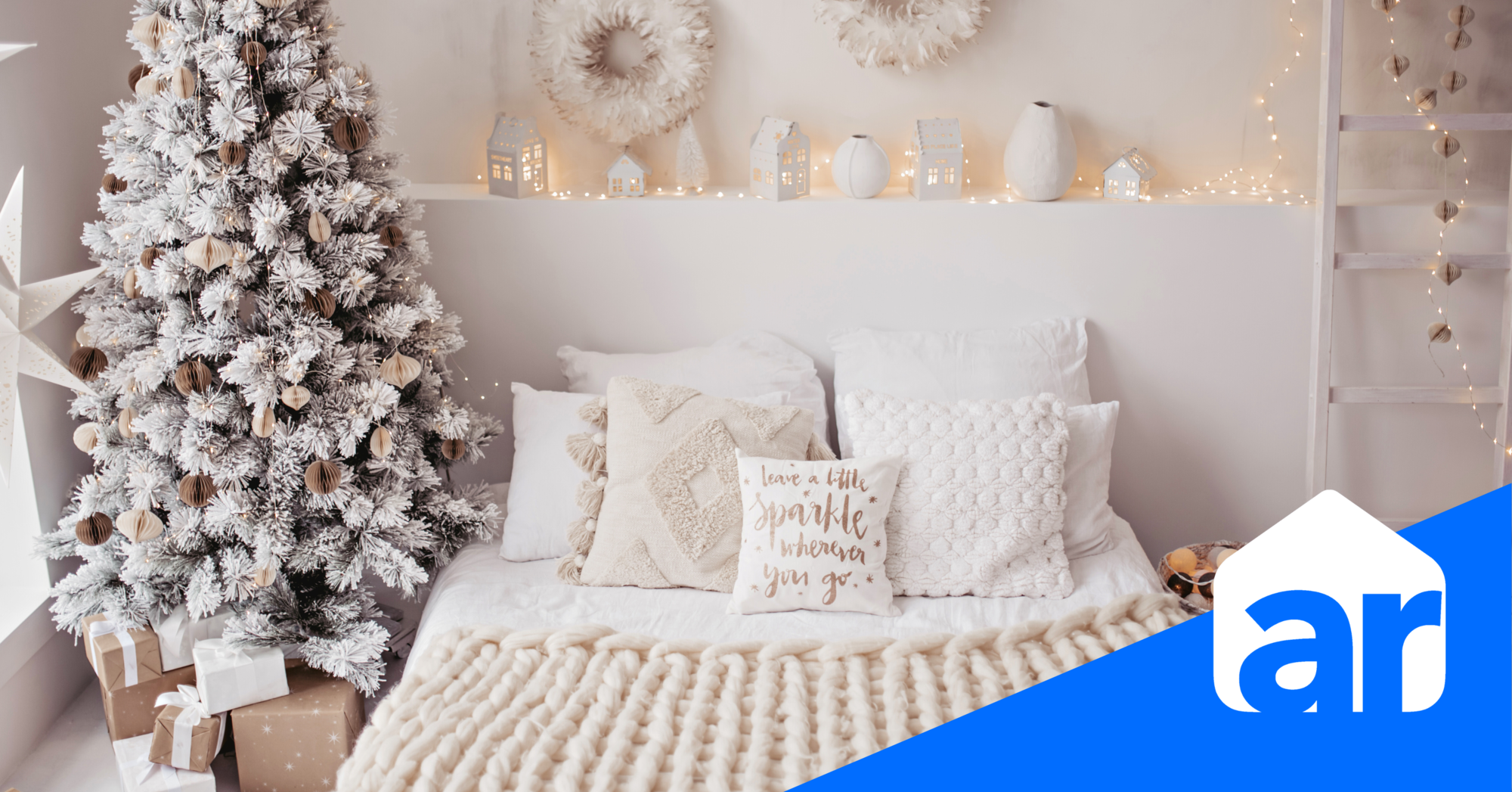 holiday decorating tips photo with cozy white bed and blankets next to a frosted christmas tree