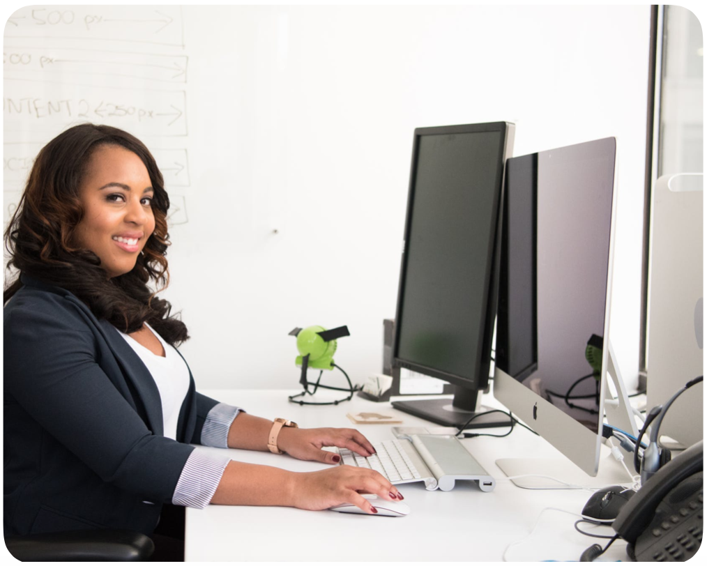 office staff at a computer smiling; linking to staff advantage