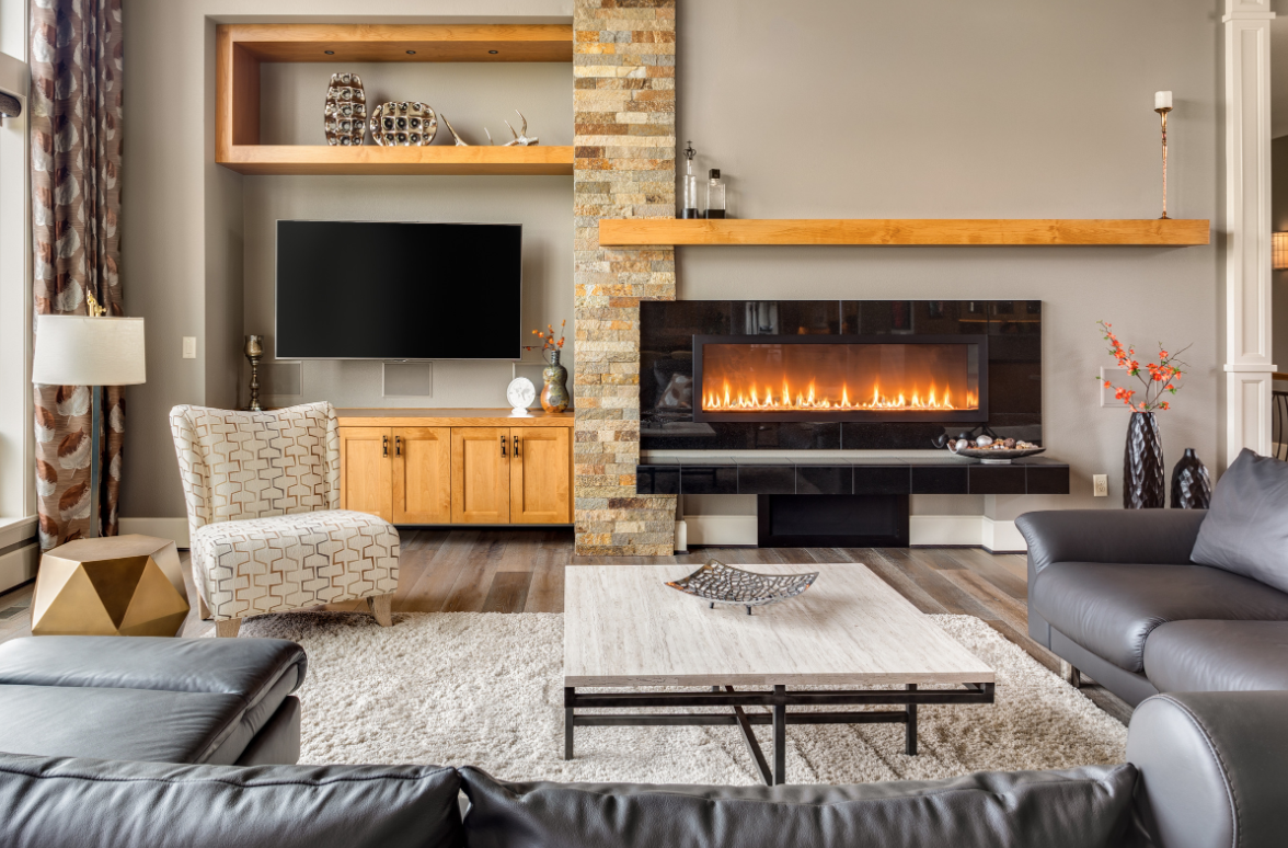 living room with wooden accents with burning fireplace tv screen and large couch